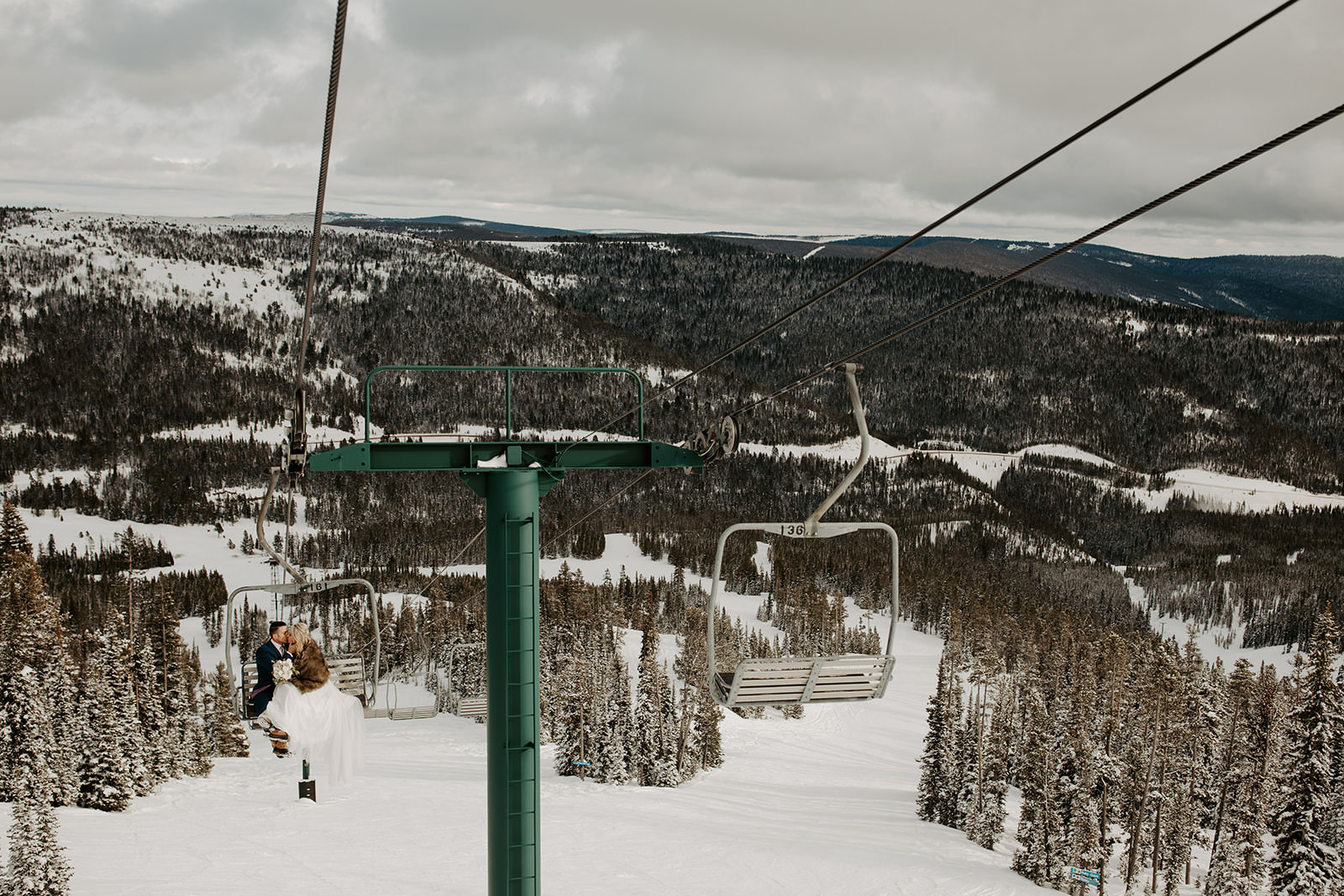 Adylee and Tyler on a ski lift during their elopement photos at Showdown in Central Montana.