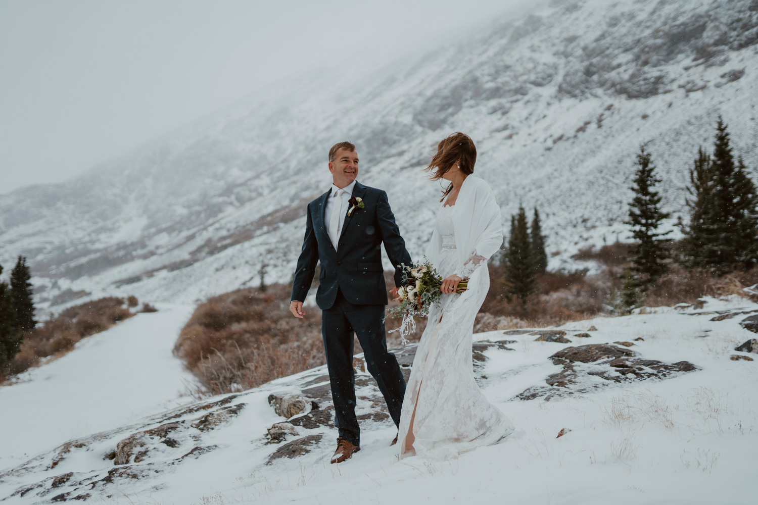 Niky and Vlad surrounded by pink fireweed on their elopement day in the Beartooth Mountains.