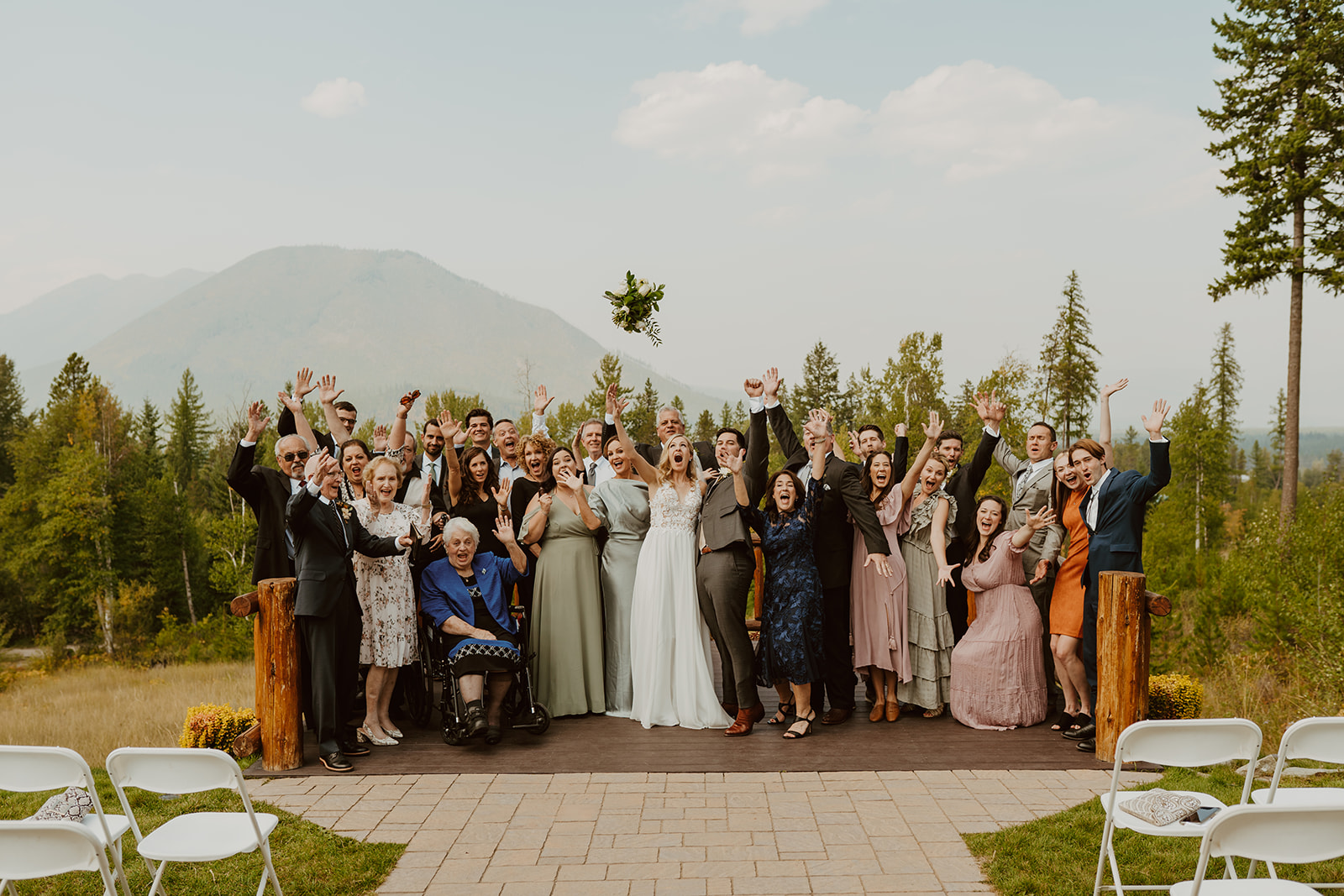 Taylor and Matthew surrounded by their family celebrating after their wedding at Glacier Raft Company.