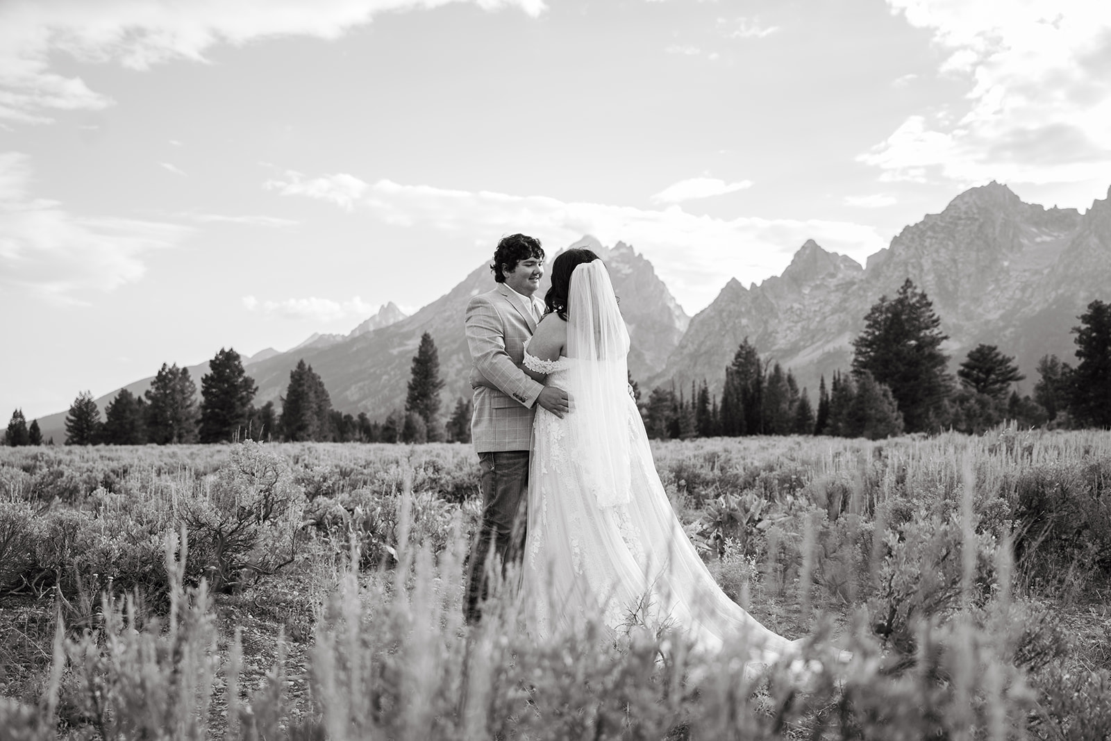 A couple smiling at eachother during their elopement in Grand Teton.